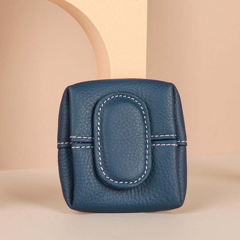 Detail shot of the leather texture on a compact black coin purse, durable and stylish