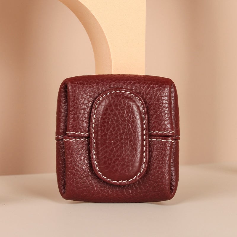 Mini teal leather coin purse next to keys, illustrating its compact size