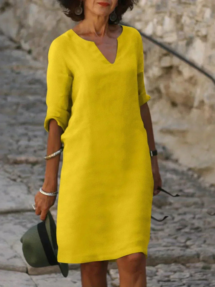 Women's stylish mini dress, featuring a V-neck, 3/4 sleeves, and a comfortable loose fit.