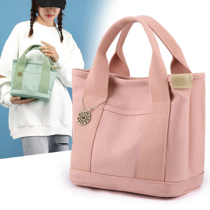 Women's multi-pocket canvas handbag, perfect for daily use, shown from the front angle