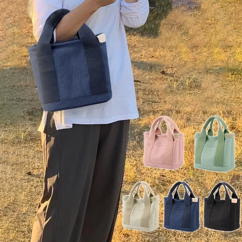 Back view of the women's canvas handbag, showing an additional secure pocket detail