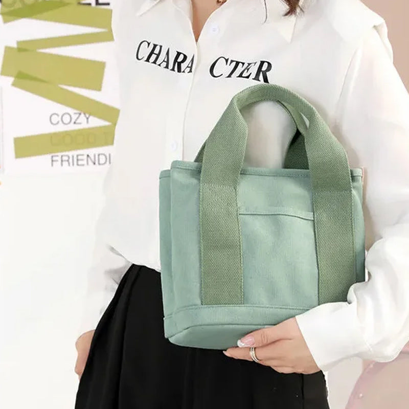 Close-up of the comfortable shoulder strap attachment on a women's daily canvas handbag