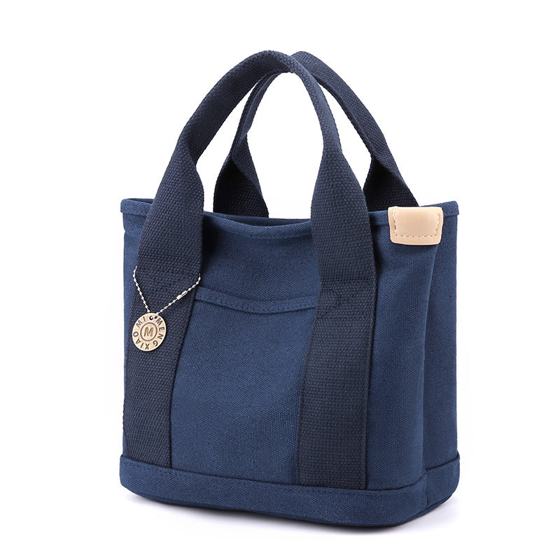 Overhead view of the women's multi-pocket canvas handbag, emphasizing its spacious design