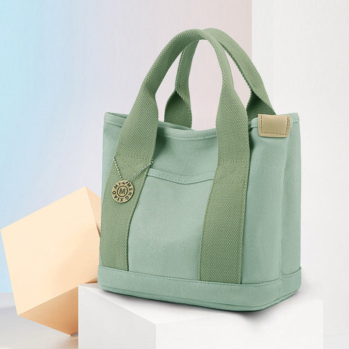Women's daily carryall: a practical canvas handbag featuring several convenient pockets