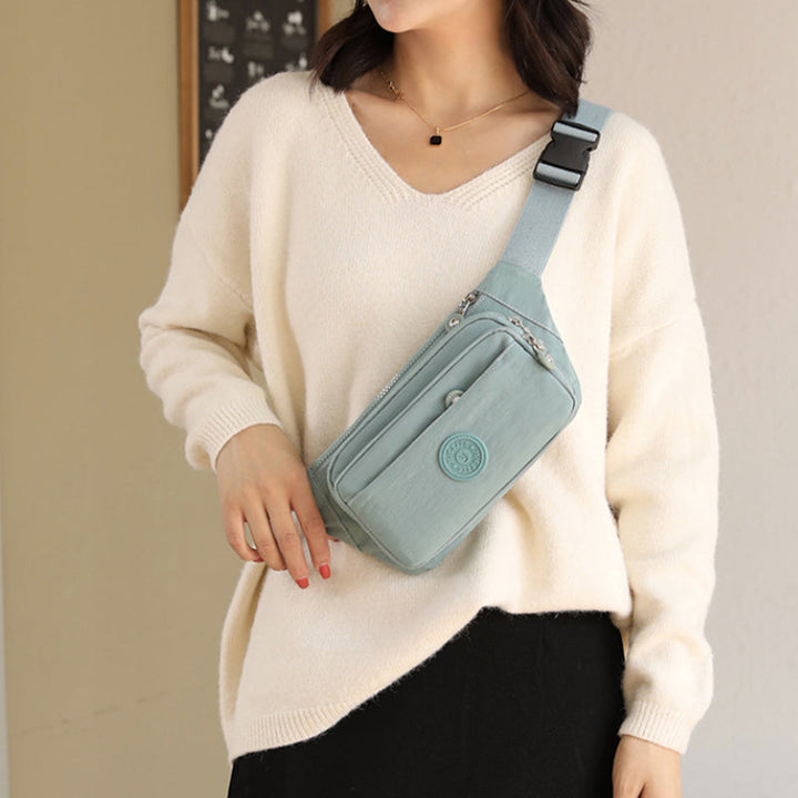 Multi-pocket women's travel crossbody bag, durable nylon material, black color, secure zippers