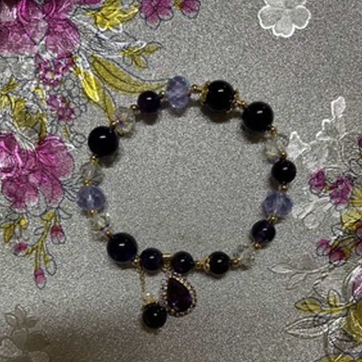 Hand modeling women's natural amethyst water drop bracelet, stunning purple jewelry
