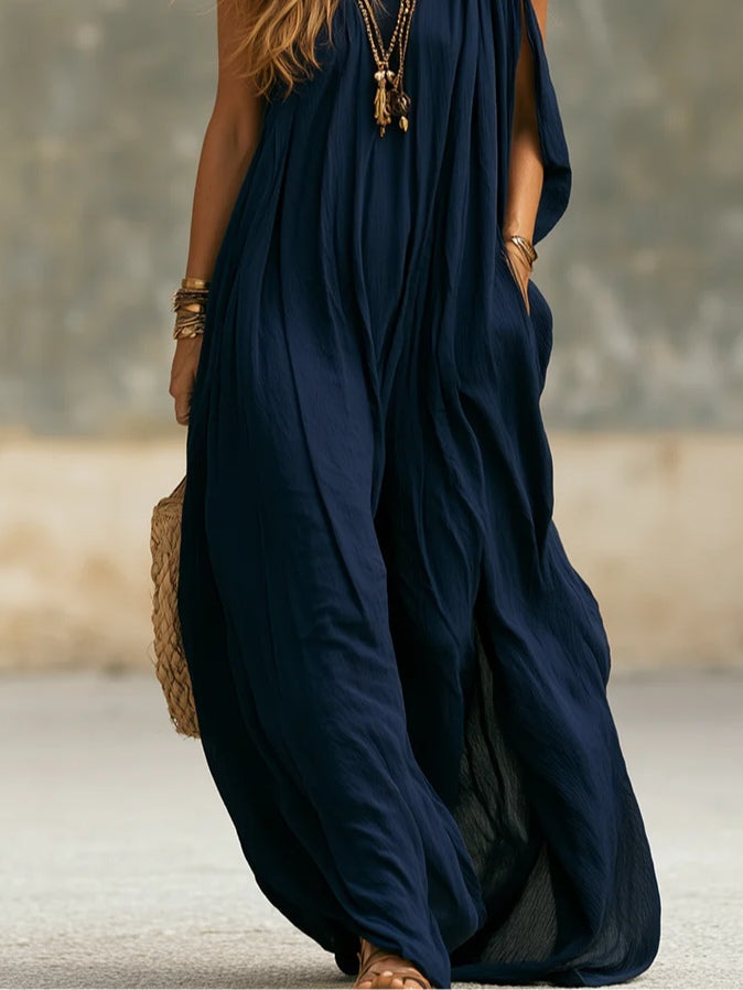 Flowy navy one-shoulder wide-leg jumpsuit for women. Bohemian style, versatile for resort, summer, or evening wear.
