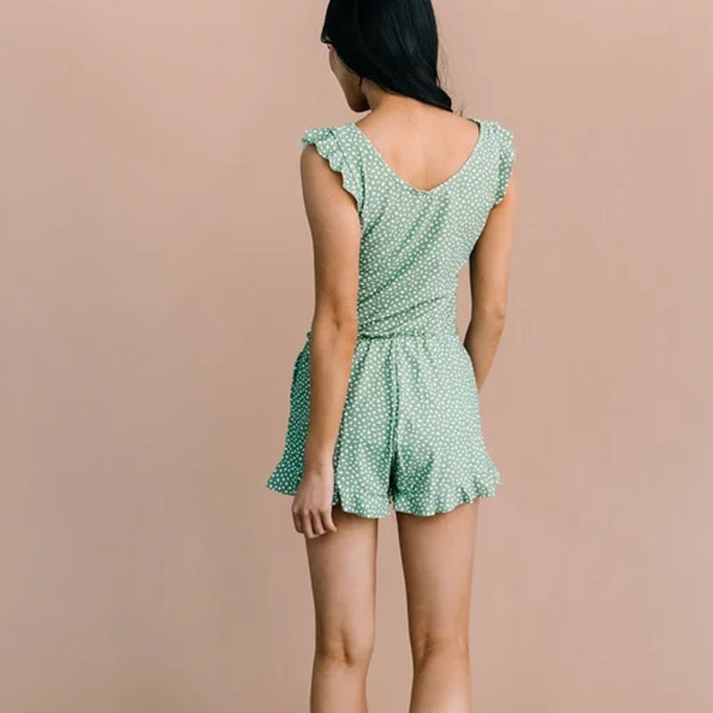 Women's swim romper with a built-in bra, shown next to a beach bag, ready for a summer outing.