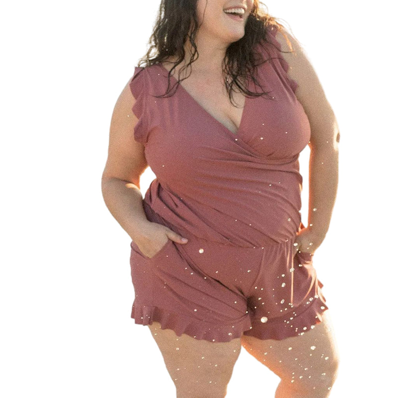 A women's swim romper in a vibrant pattern, quick-dry, with a built-in bra, perfect for tropical vacations.