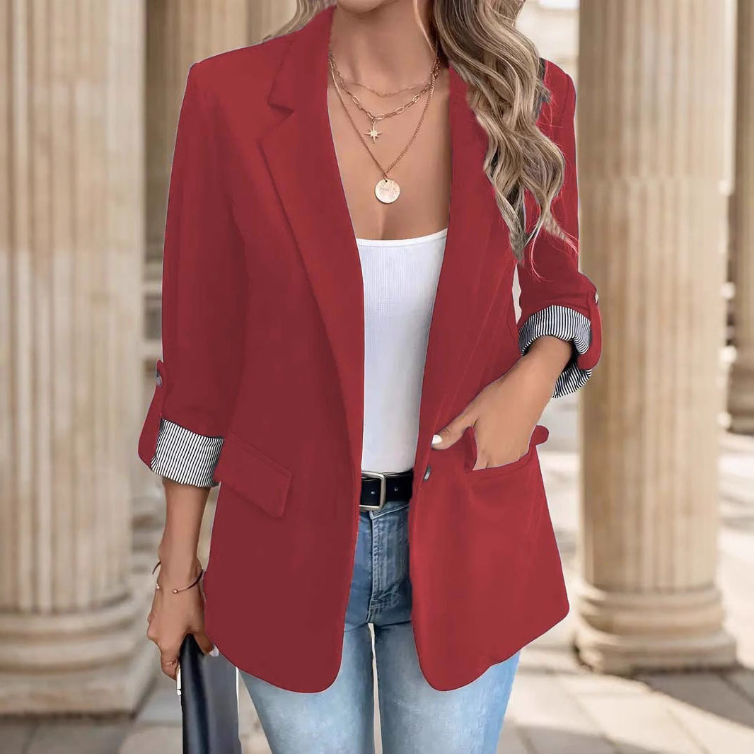 Elegant women's open front blazer with distinctive striped cuffs for a modern office look.