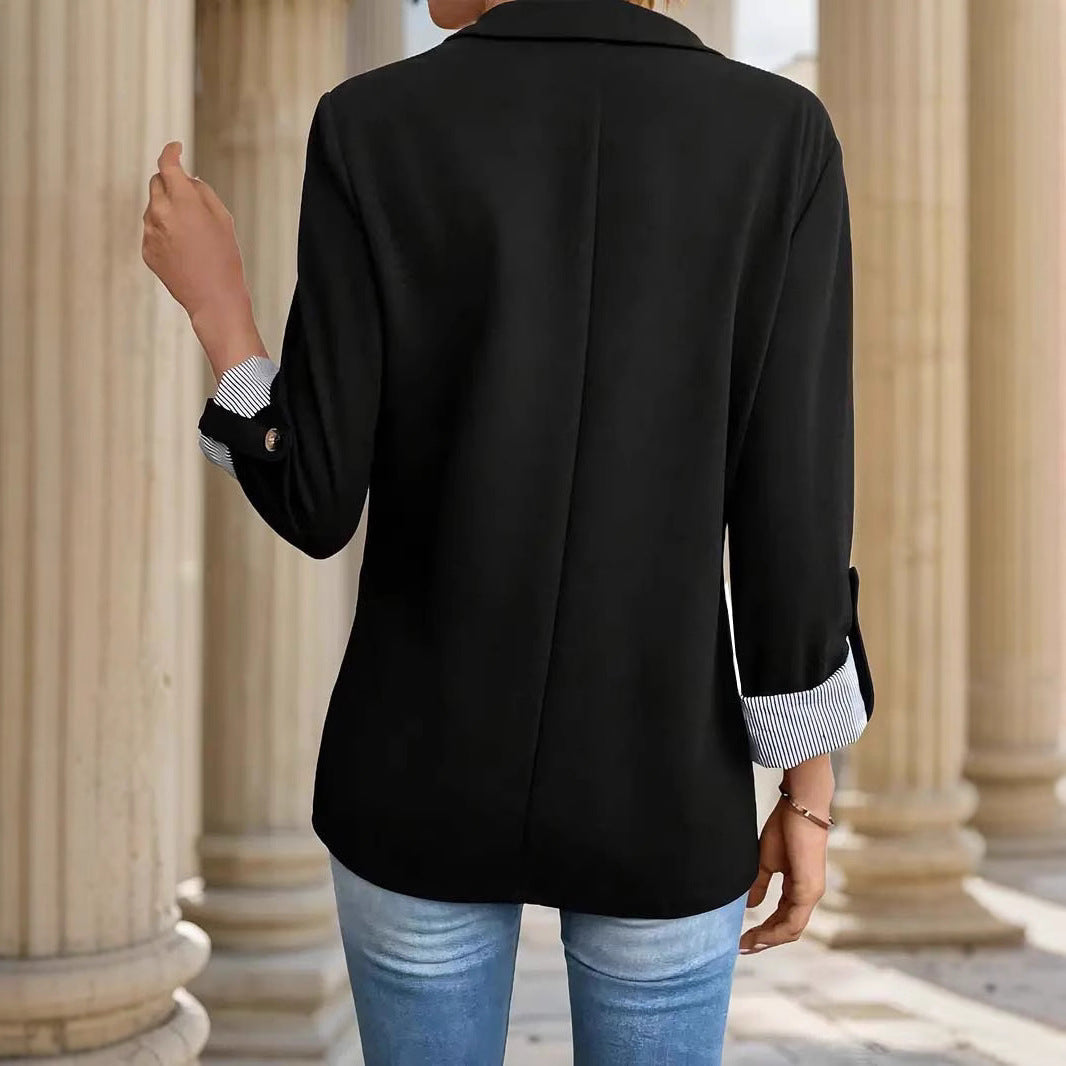 Fashionable women's blazer with roll sleeves, open front, and eye-catching striped cuffs.