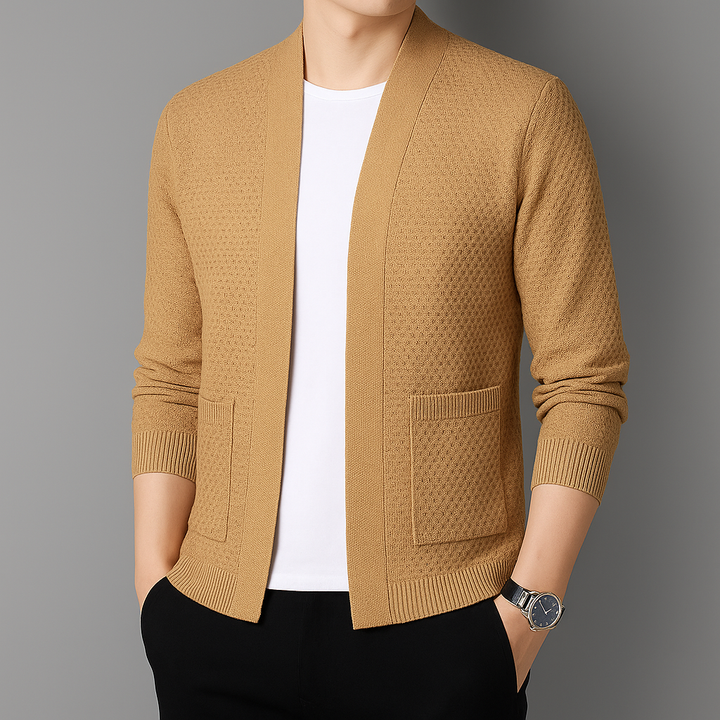 Close-up of the textured knit fabric on a women's layering cardigan with a ribbed hem.