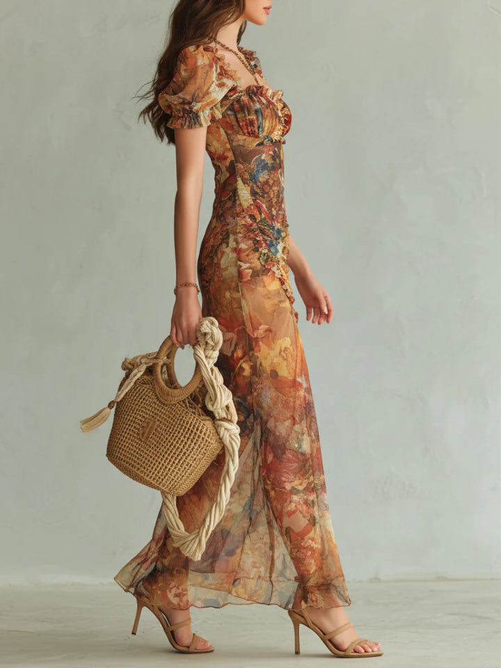 Vibrant orange floral maxi dress for women, featuring a flattering sweetheart neckline and ruched details, ideal for galas.