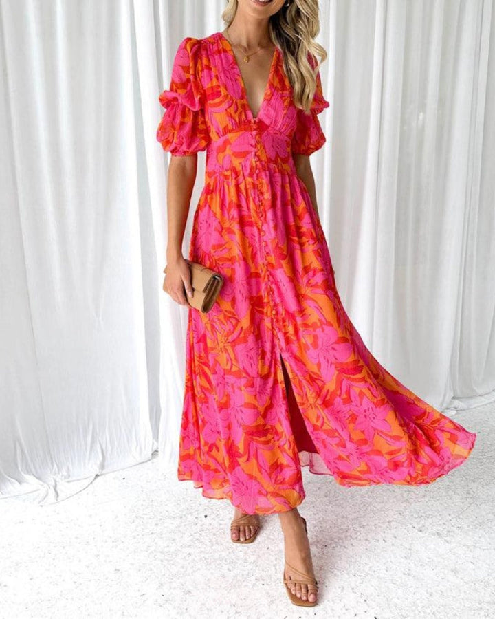 Women's orange printed maxi dress with elegant V-neck and stylish puffed sleeves, perfect for summer fashion.