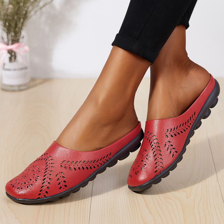 Slip-on women's comfort sandals featuring a round toe & arch support for all-day wear.