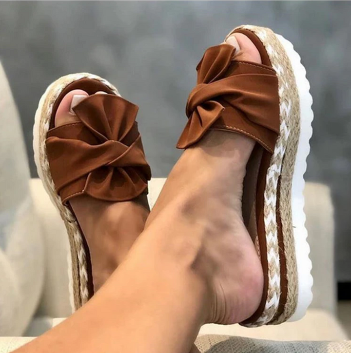 Women's slip-on orthopedic platform sandals adorned with a stylish bow, offering all-day summer comfort.