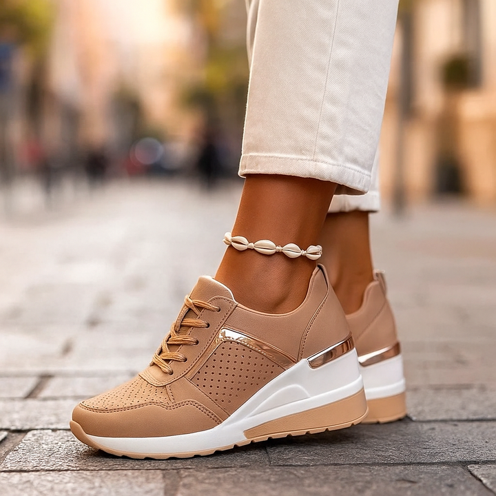 Close-up of women's cushioned orthopedic sneakers, highlighting the breathable mesh and metallic accents.