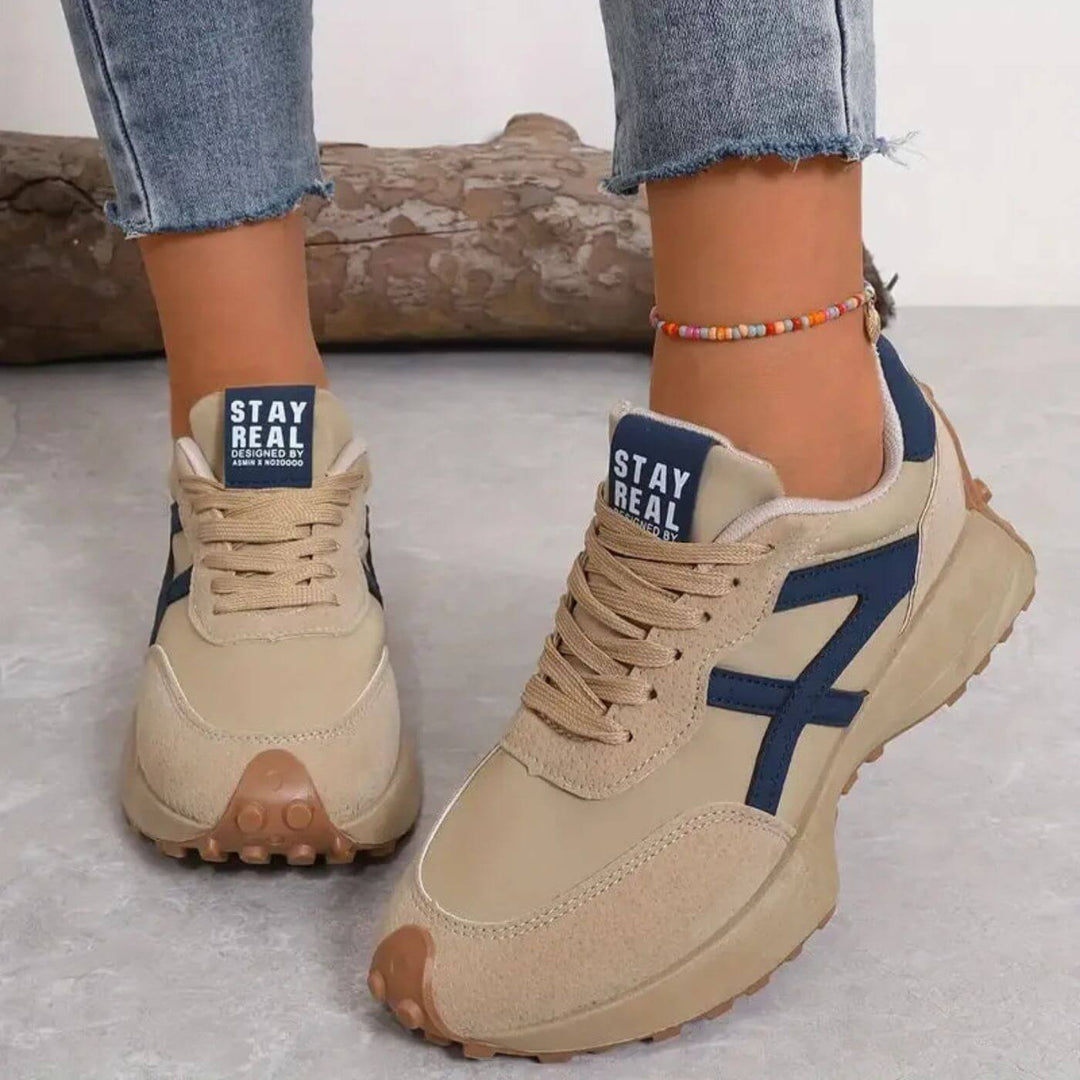 Comfortable women's walking sneakers with orthopedic support, featuring a stylish panel design & secure lace-up closure.