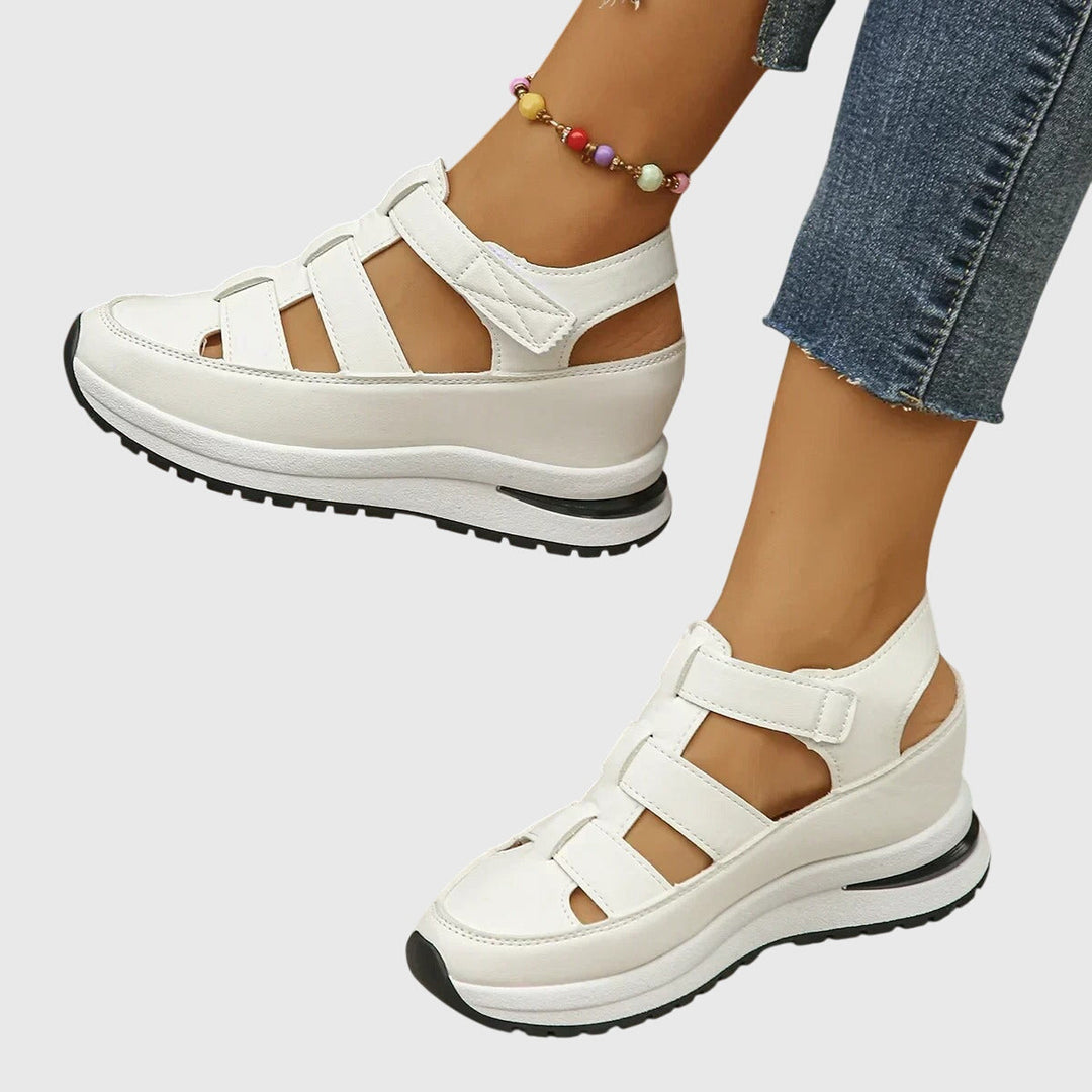 Close-up of women's orthopedic sandals, showcasing the adjustable arch support & comfortable footbed.