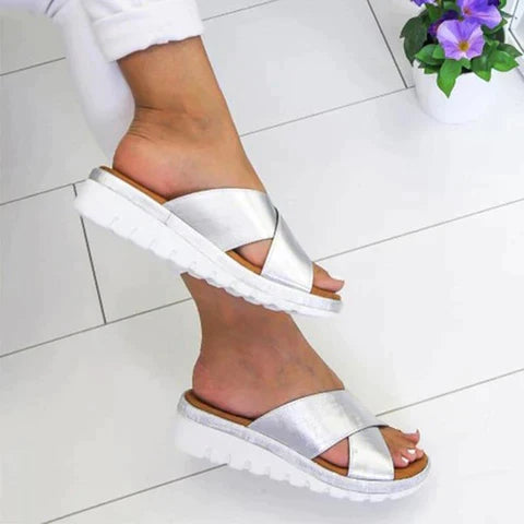 Supportive women's orthopedic sandals with arch support & adjustable straps, offering pain relief for feet.
