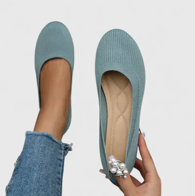 Detail of the breathable mesh upper and reinforced arch support in women's comfortable walking shoes.
