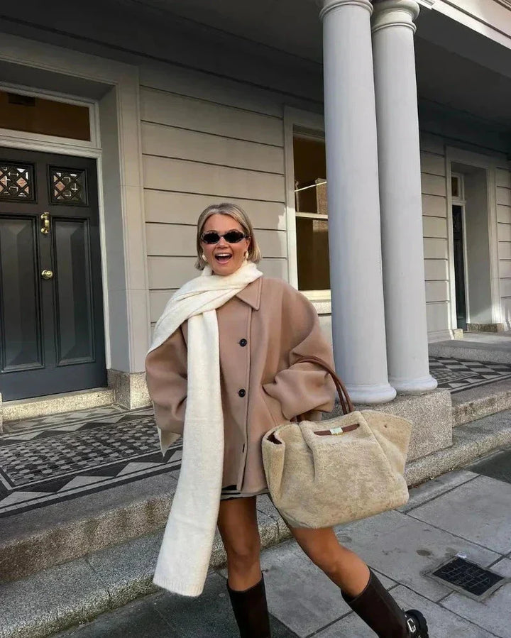 Chic women's oversized button-up jacket in a neutral tone, perfect for layered spring/fall looks.