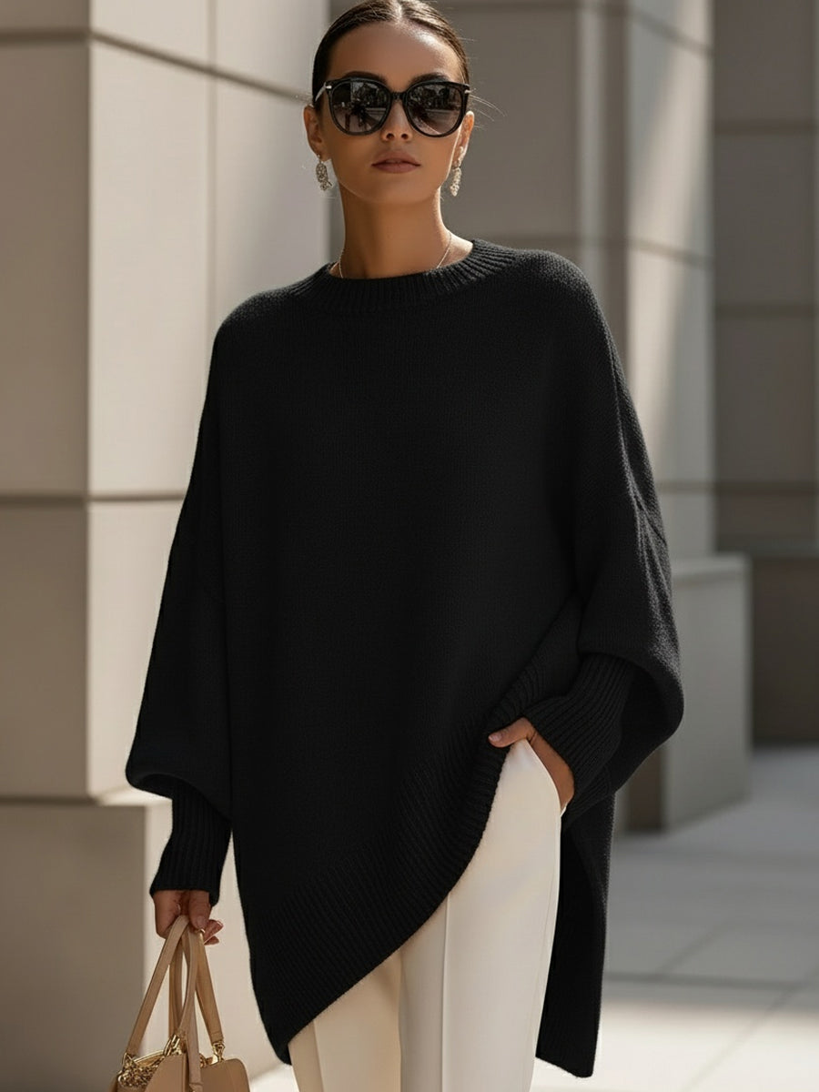 Women's elegant oversized poncho sweater with a comfortable cape design and chic batwing sleeves for versatile wear.