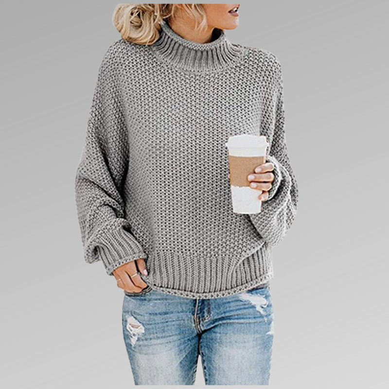 Woman wearing a cozy oversized chunky knit turtleneck sweater, ideal for comfortable fall and winter fashion.