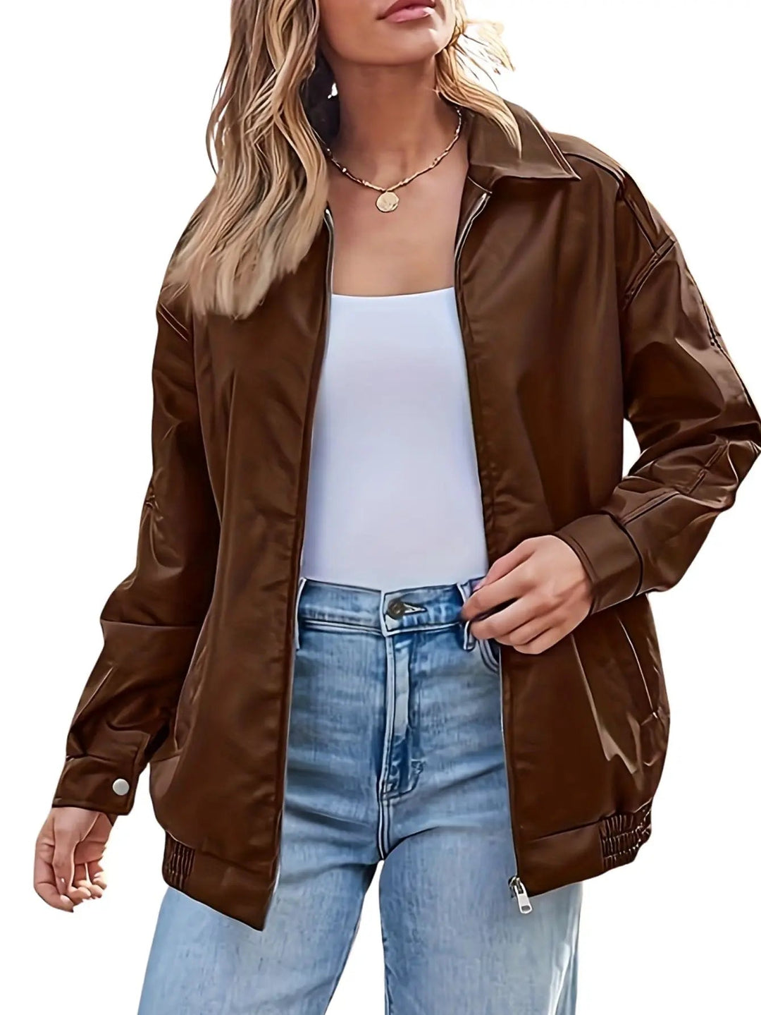 Close-up of a women's oversized faux leather bomber jacket texture, highlighting its fashionable details.