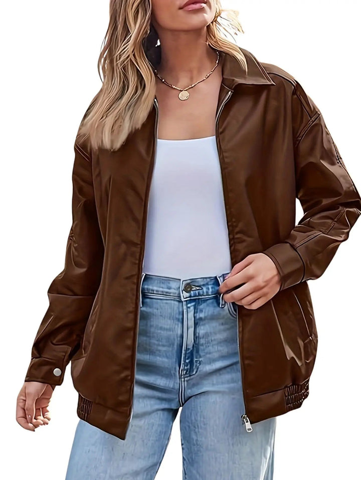 Close-up of a women's oversized faux leather bomber jacket texture, highlighting its fashionable details.