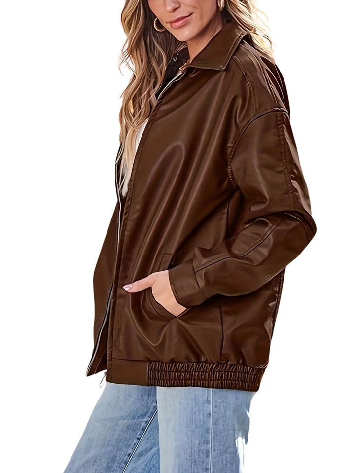 Model wearing a women's oversized faux leather bomber jacket, showcasing its casual and trendy fit.