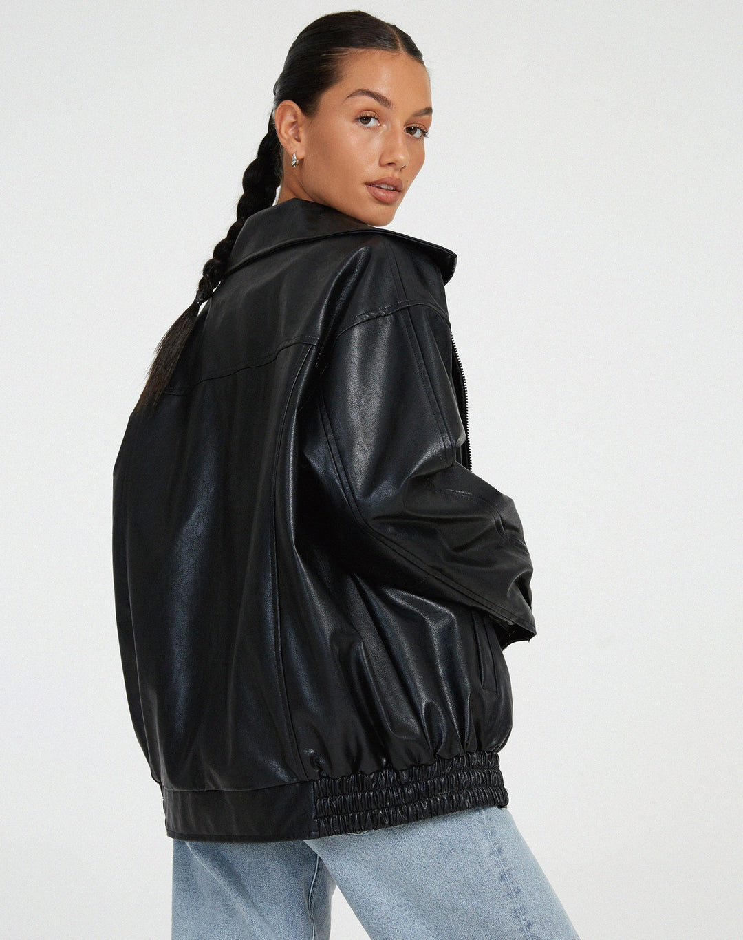 Women's oversized faux leather bomber jacket with a front zipper closure, practical for fall weather.