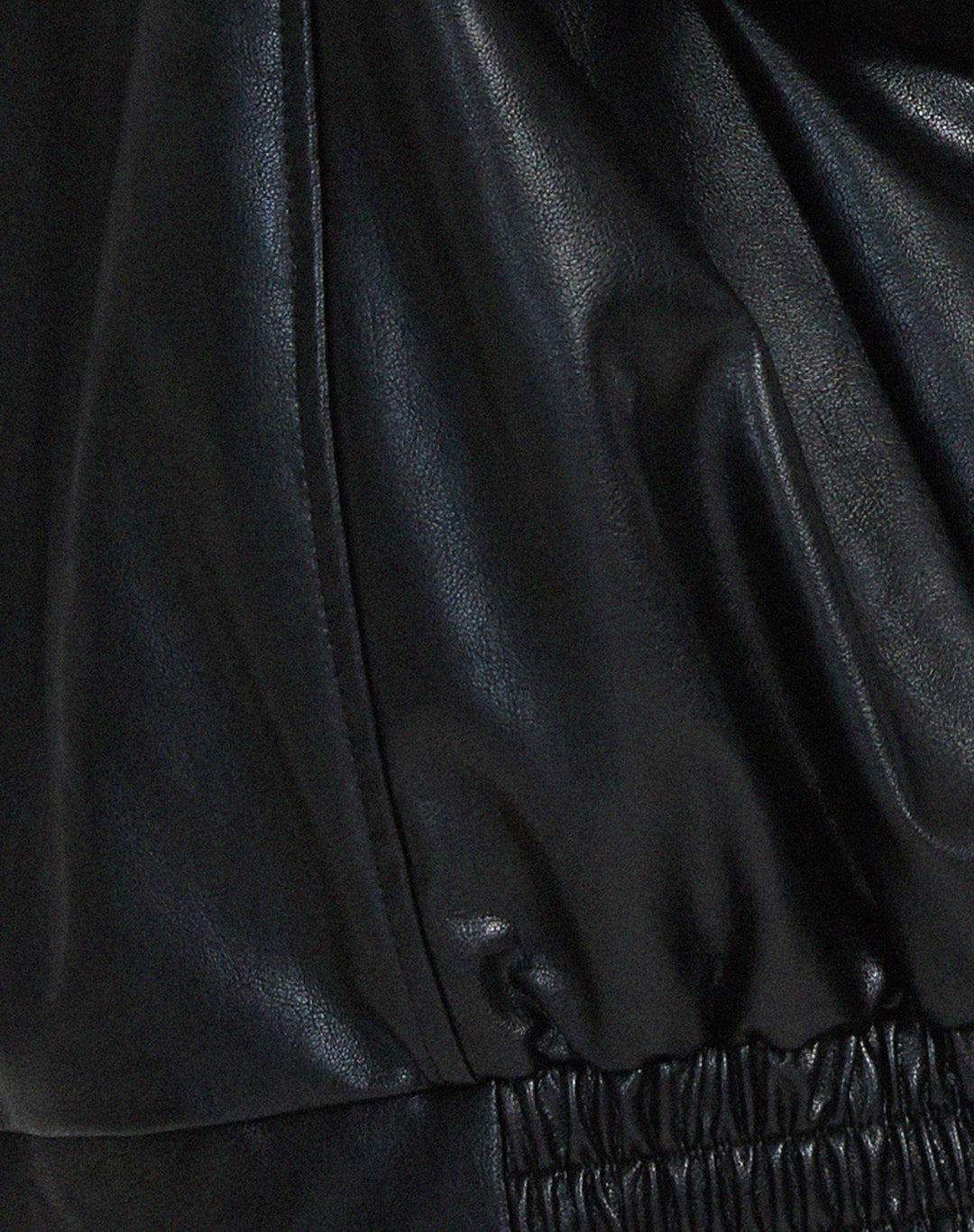 Two women's oversized faux leather bomber jackets, one brown and one black, for versatile fall styling.