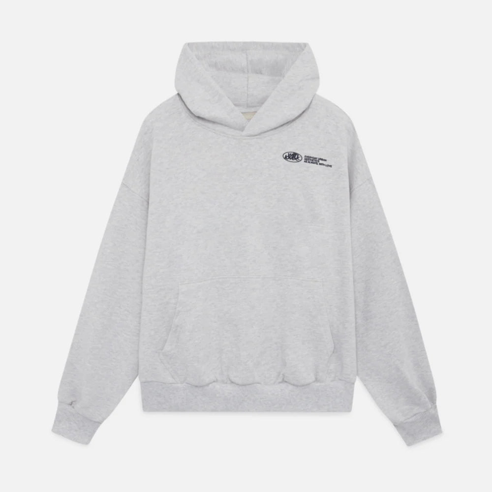 Woman wearing a stylish oversized graphic cropped hoodie, showcasing trendy streetwear apparel.