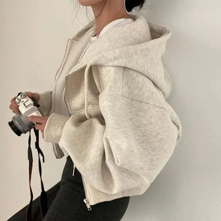 Modern women's oversized hooded vest, short cut, perfect for casual autumn fashion & comfortable layering.