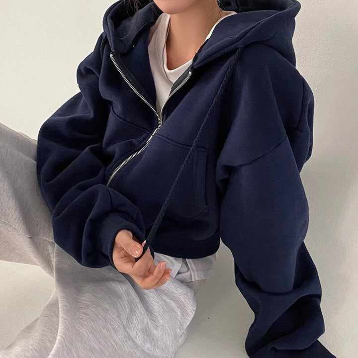 Stylish women's oversized vest with hood & short cut. Versatile for casual streetwear & modern layering.