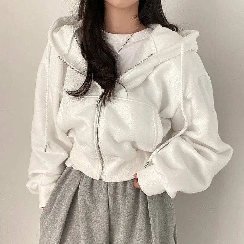 Comfortable women's oversized hooded vest, short cut. Contemporary ladies apparel for casual & streetwear.