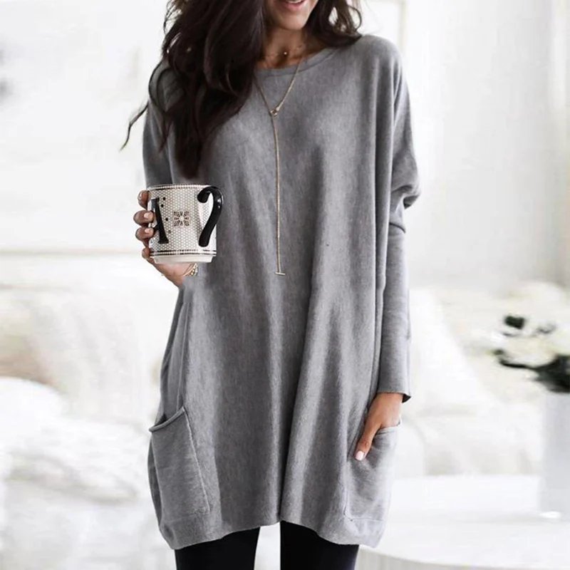 Modern women's oversized long sleeve tunic top with dual pockets, offering both style and utility.
