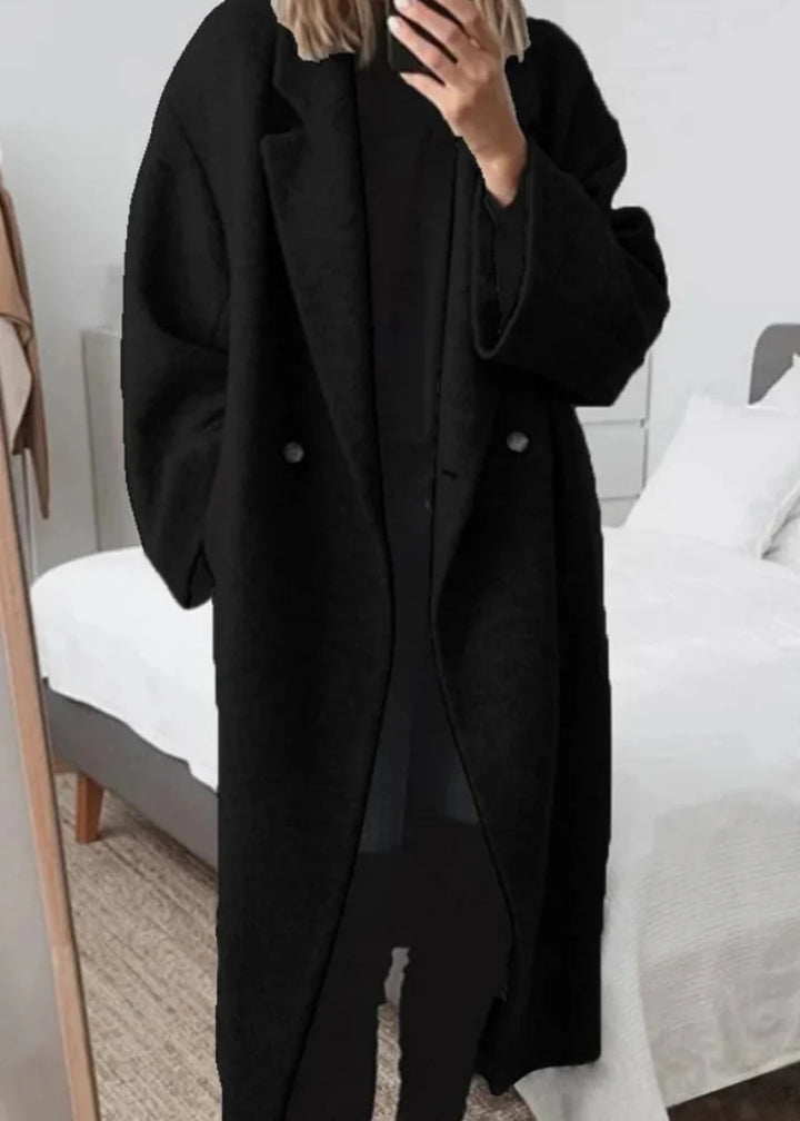 Close-up of a cozy women's oversized maxi winter coat fabric, highlighting its luxurious warmth and classic style.