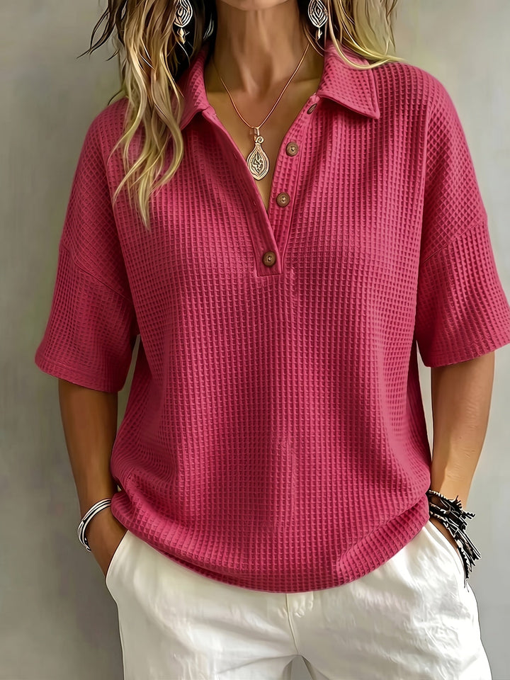 Chic women's oversized polo top with a relaxed fit, drop shoulder, and classic button placket detail.