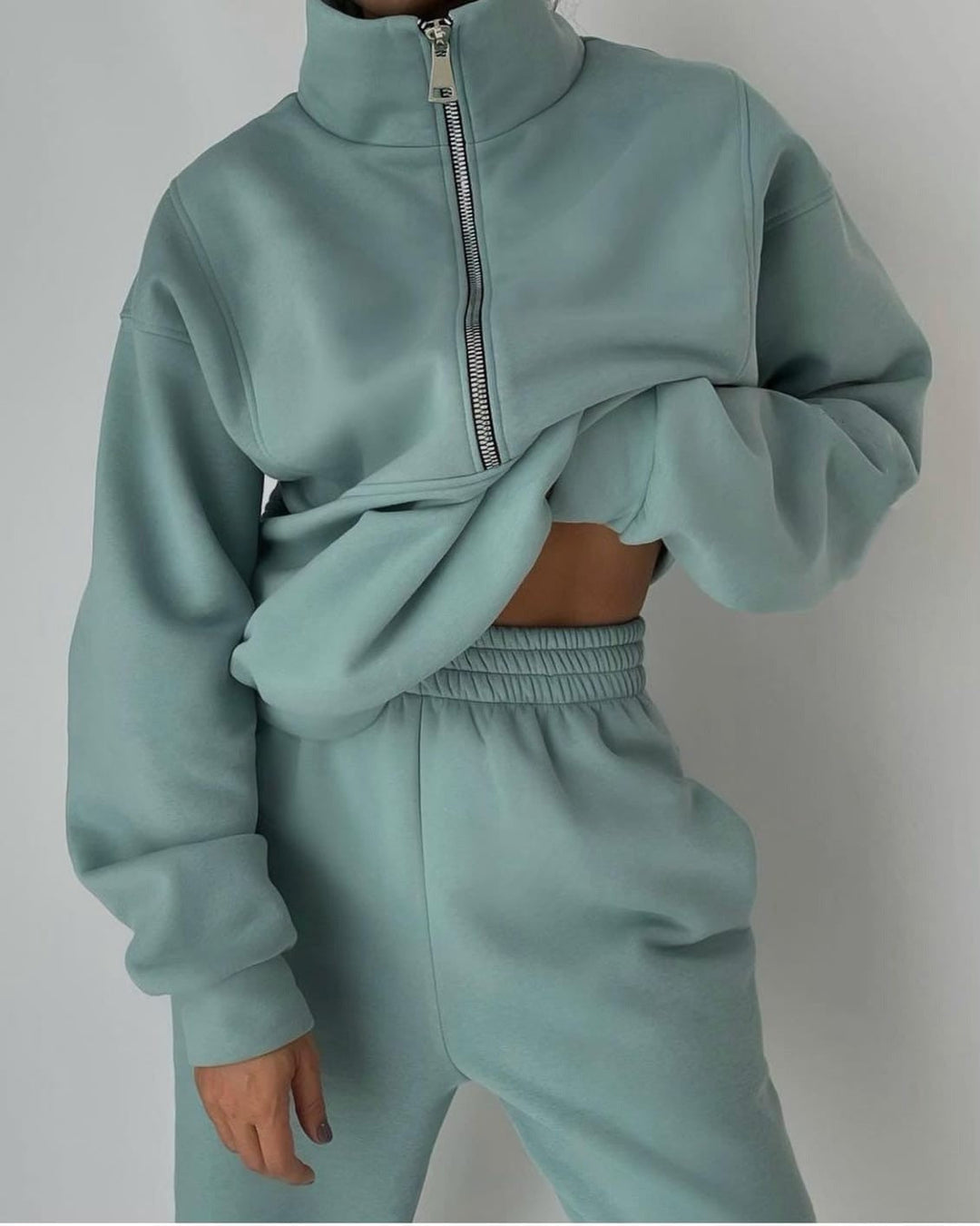 Women's oversized two-piece lounge set in soft, heather grey fabric, perfect for casual athleisure wear.