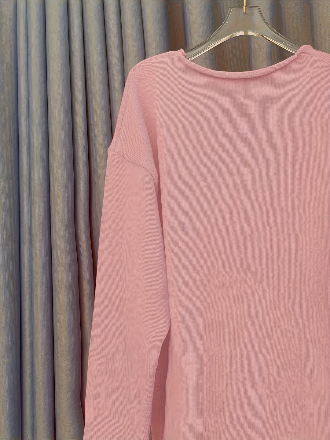 Ladies' stylish oversized V-neck patterned pullover, offering warmth and a chic casual look.