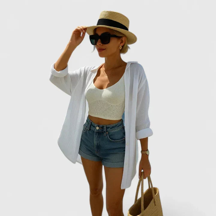 Women's oversized white beach shirt with blue evil eye embroidery. Perfect resort wear cover-up or summer fashion statement.