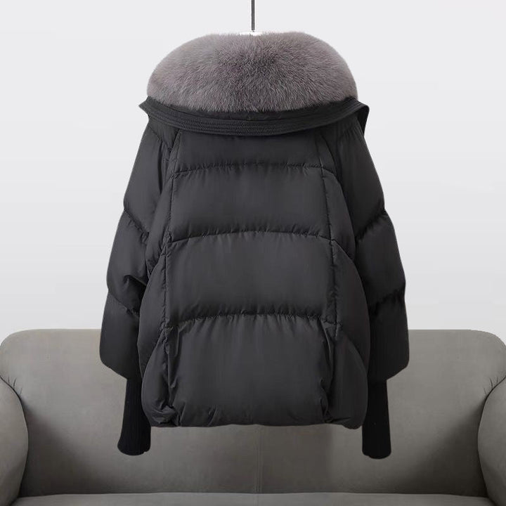 Warm women's winter jacket with luxurious fur collar, showcasing padded design for comfort.