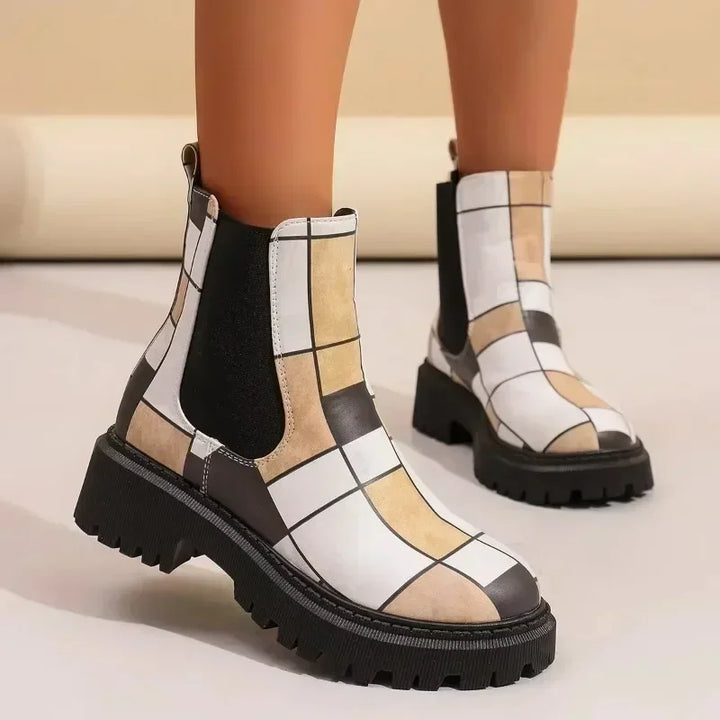 Close-up of women's patchwork ankle boots, highlighting the varied textile craftsmanship and lug sole.