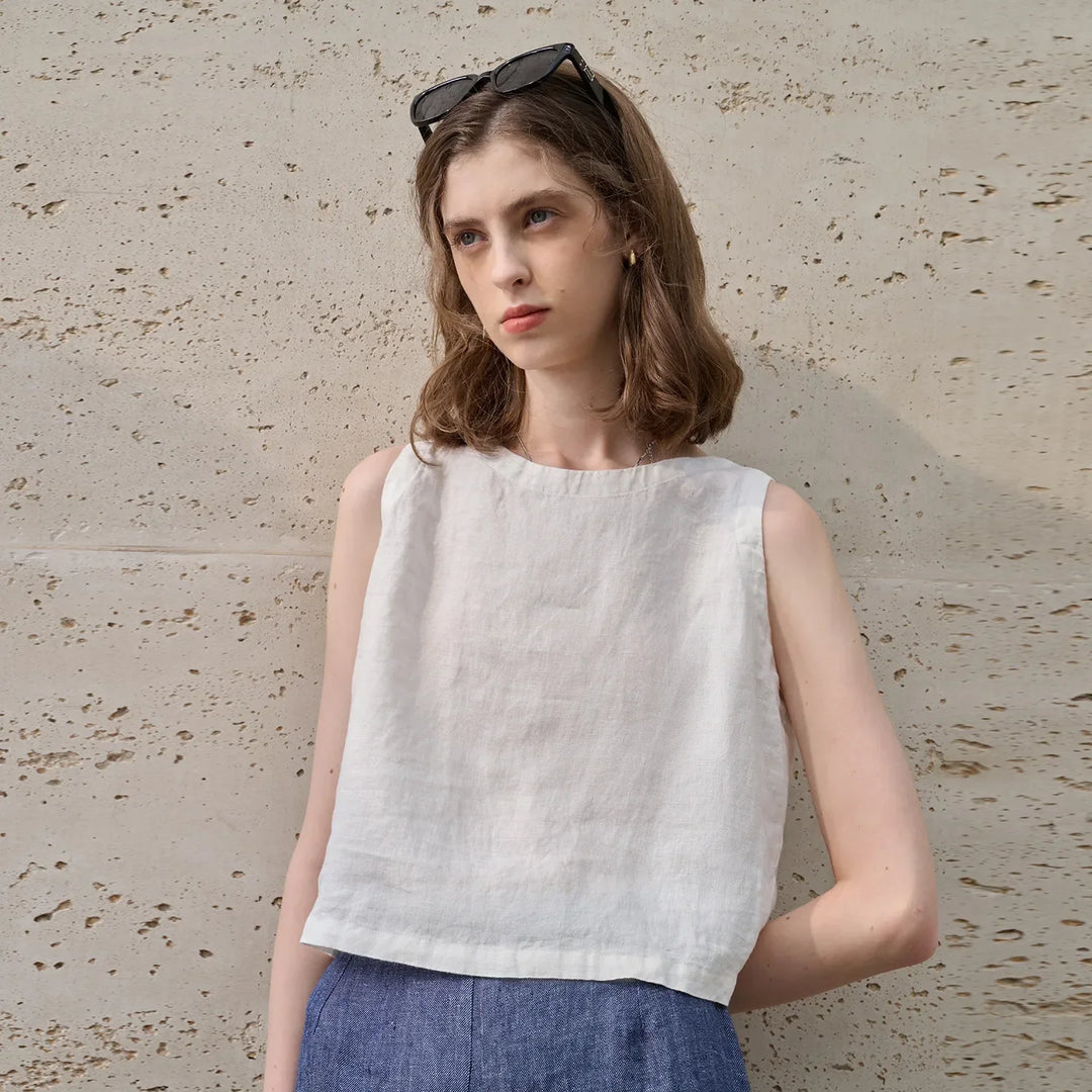 Asymmetric hem crop top for women, sleeveless and crew neck, a modern and stylish casual wear option.