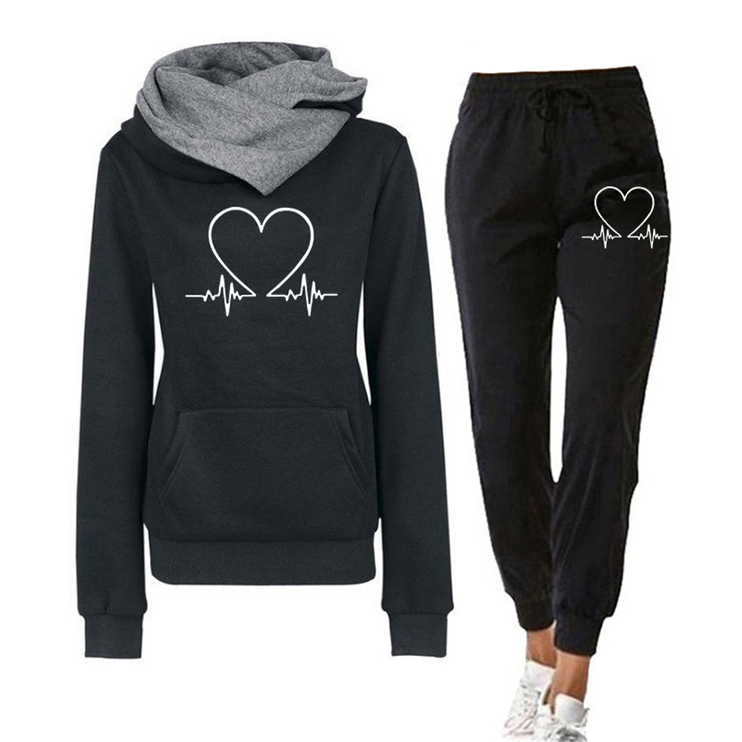 Women's pink relaxed fit tracksuit, two-piece set with heart graphic hoodie and matching joggers, comfortable loungewear.