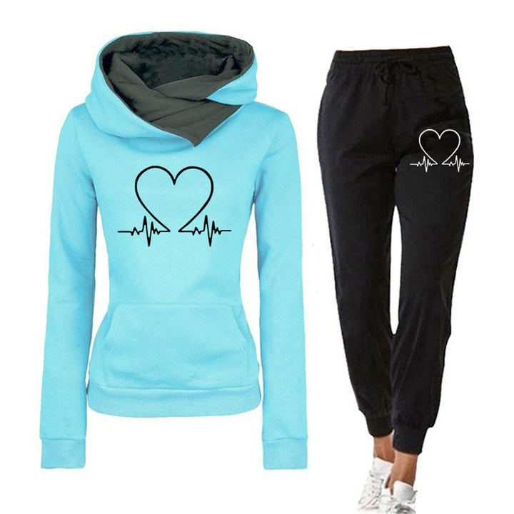 Casual grey women's athleisure tracksuit, relaxed fit hoodie & joggers with a subtle heart graphic, perfect for comfort.