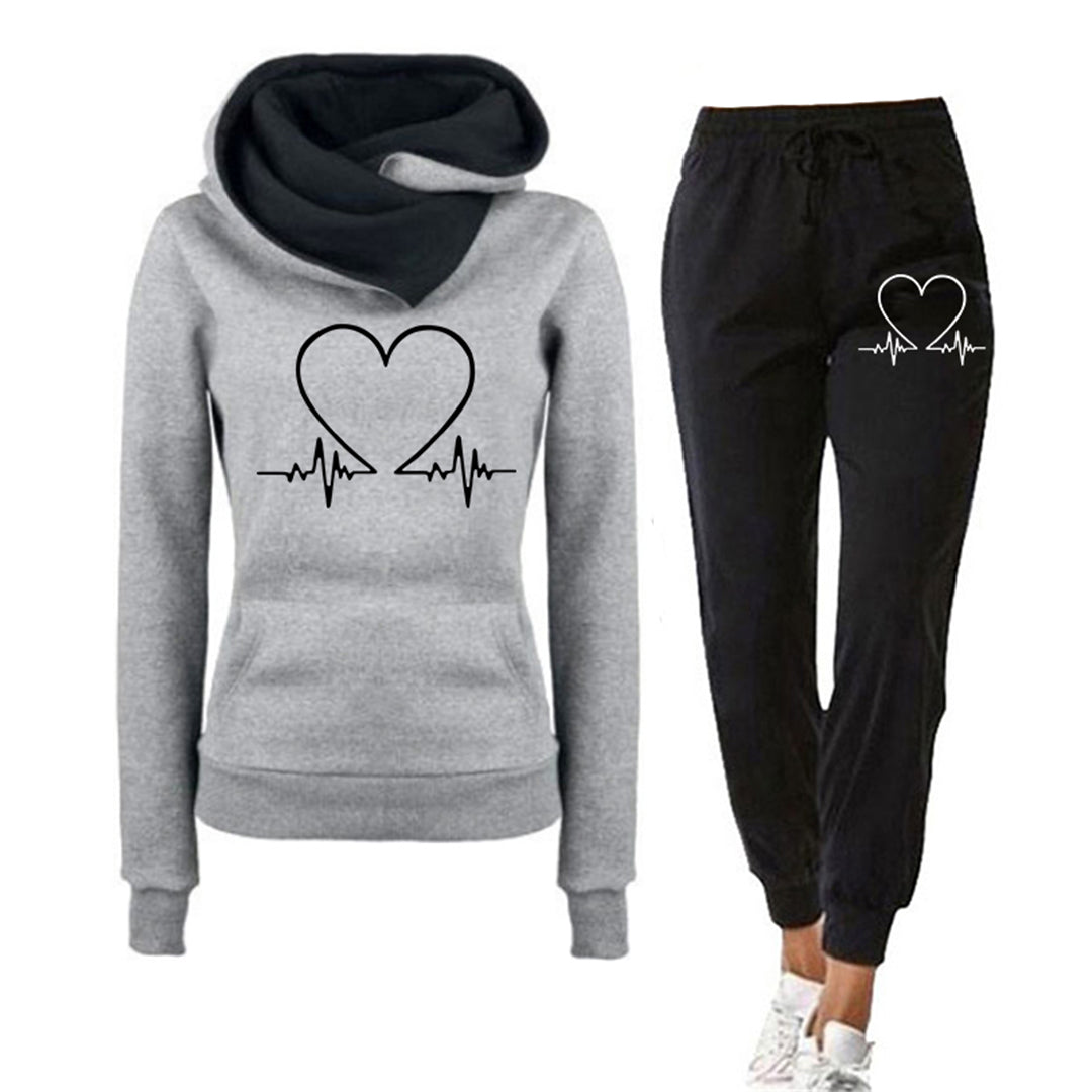 Dark blue women's two-piece tracksuit, relaxed fit with heart graphic, featuring a cozy hoodie and matching jogger pants.