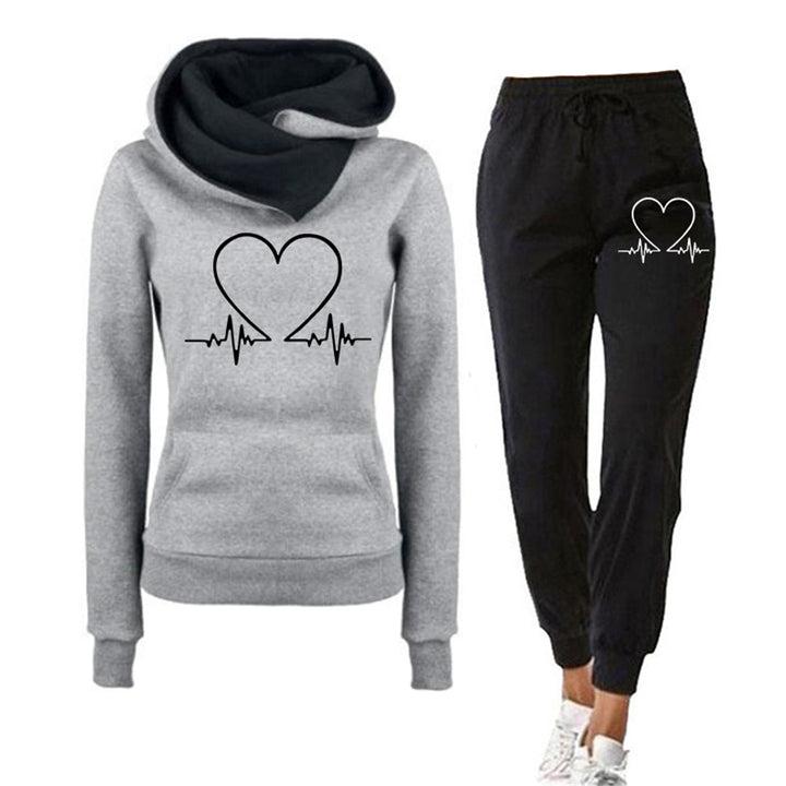 Dark blue women's two-piece tracksuit, relaxed fit with heart graphic, featuring a cozy hoodie and matching jogger pants.